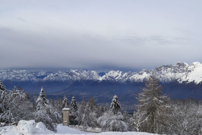 Snow covered landscape against sky