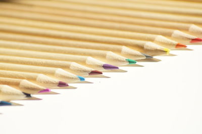 Color pencils arranged on white background