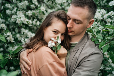 Portrait of bride and bridegroom holding bouquet