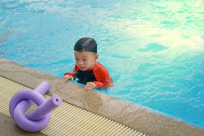 High angle view of boy toy in swimming pool