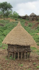 Old house on field against sky