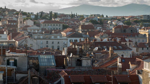 High angle view of houses in town against sky