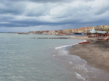 Scenic view of sea against sky in city