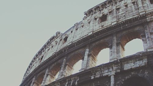 Low angle view of coliseum against clear sky