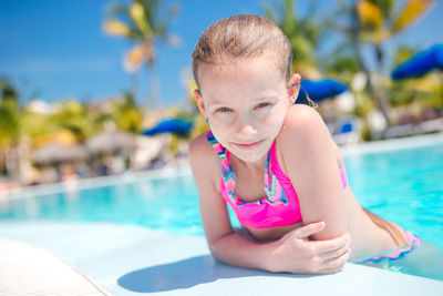 Portrait of young woman swimming in pool