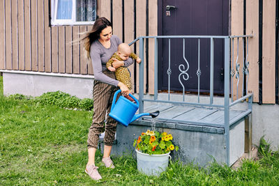 Side view of young man standing in yard