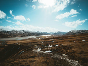 Scenic view of landscape against sky during winter