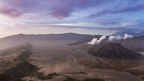 View of volcanic landscape against cloudy sky