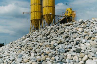 Rocks on pier by sea against sky