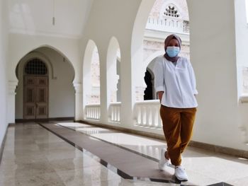 Full length of woman standing in building