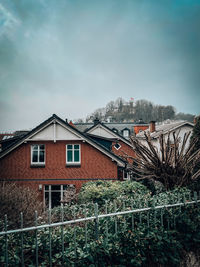 Houses in city against sky during winter