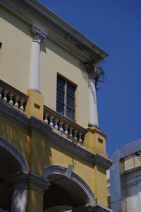 Low angle view of building against blue sky