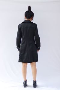Rear view of woman standing against white background