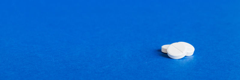 Close-up of pills on blue background