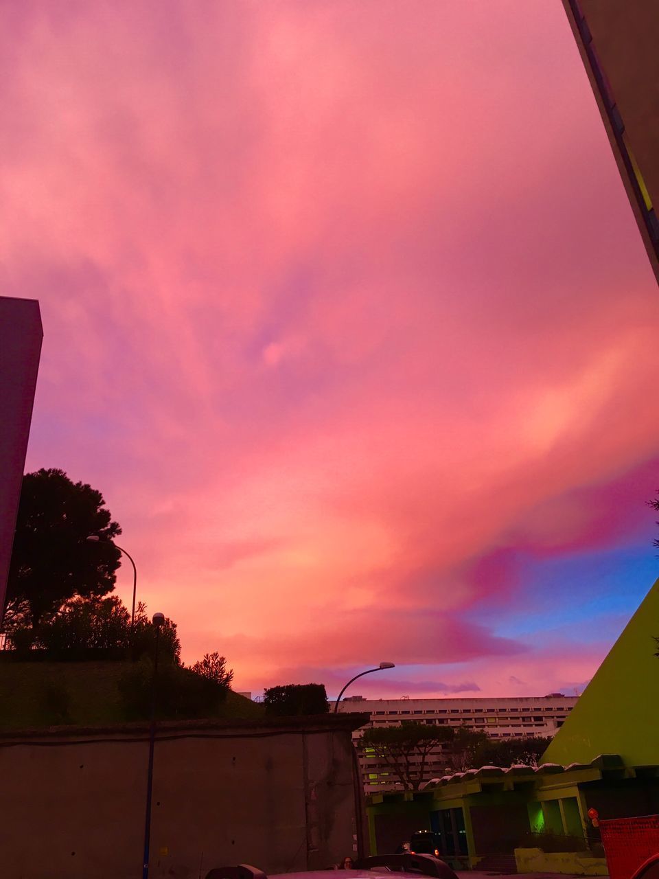 BUILDINGS AGAINST DRAMATIC SKY DURING SUNSET