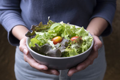 Midsection of man holding bowl