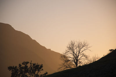 Scenic view of mountains against clear sky during sunset