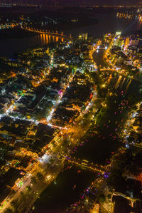 High angle view of illuminated buildings in city at night