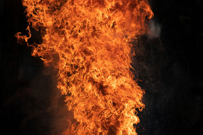 Close-up of bonfire against black background