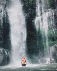 Man surfing in waterfall