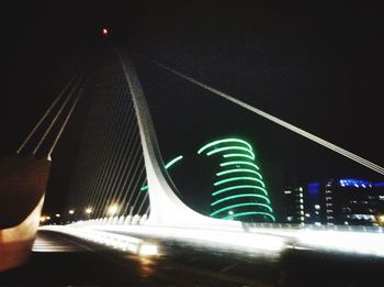 Low angle view of illuminated road in city against sky