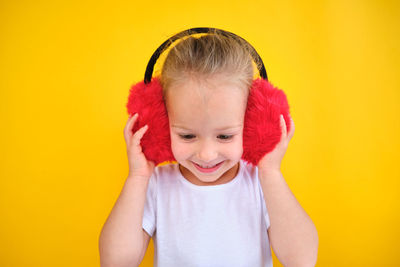 Portrait of girl against yellow background