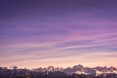 Scenic view of snowcapped mountains against sky during sunset