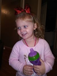 Portrait of a smiling girl holding camera