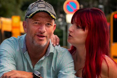 Close-up portrait of mature man with daughter outdoors