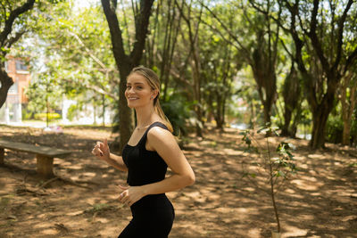 Young woman running and jogging at a park outdoors. athlete female person during workout.healthy 