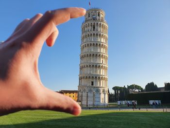 Midsection of person tower against sky