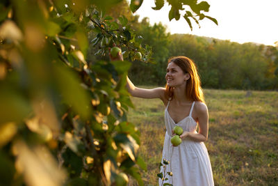 Full length of woman against tree