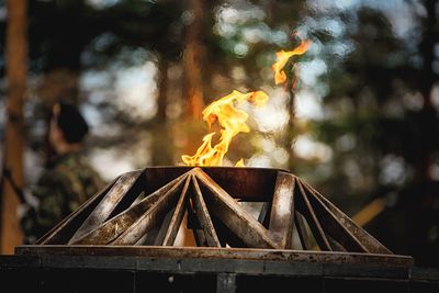 Close-up of fire pit against trees