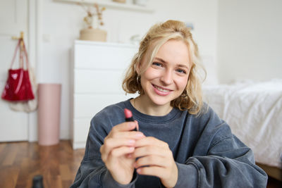 Portrait of young woman using mobile phone