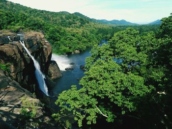 Scenic view of river with mountains in background