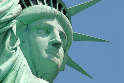 Close-up of statue against blue sky