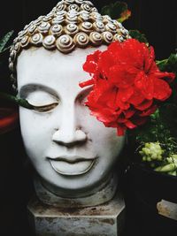 Close-up of statue of red flower
