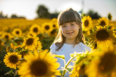 Portrait of smiling girl on sunflower