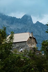 Houses on mountain against sky