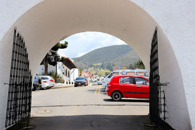 Cars on road against mountain in city