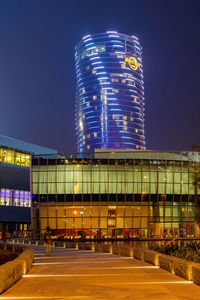 Low angle view of illuminated buildings against sky at night