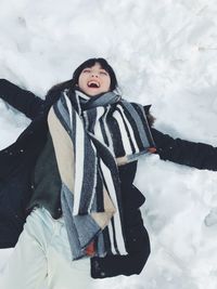 Young female lying on snow