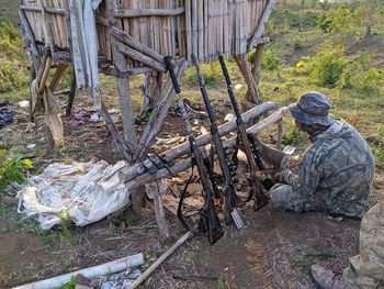 Man working on wood in field