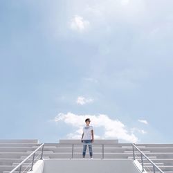 Woman standing on road against sky