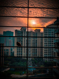 Low angle view of buildings against sky during sunset