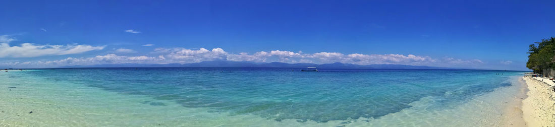 Panoramic view of sea against blue sky