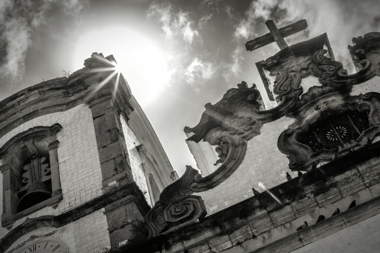 low angle view, sky, built structure, building exterior, architecture, statue, sculpture, art and craft, human representation, cloud - sky, art, history, religion, creativity, old, spirituality, cloud, cloudy, place of worship