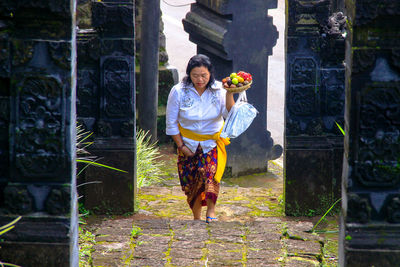 Portrait of woman smiling while holding flowers