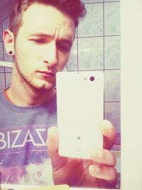 Close-up of young woman holding smart phone