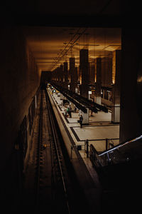 Railroad tracks in city at night